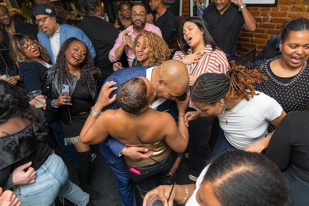 An embrace in the middle of the dance floor — the room surrounding them