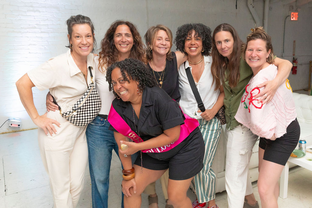 The 60-year-old surrounded by her crew — front and center, everyone beaming