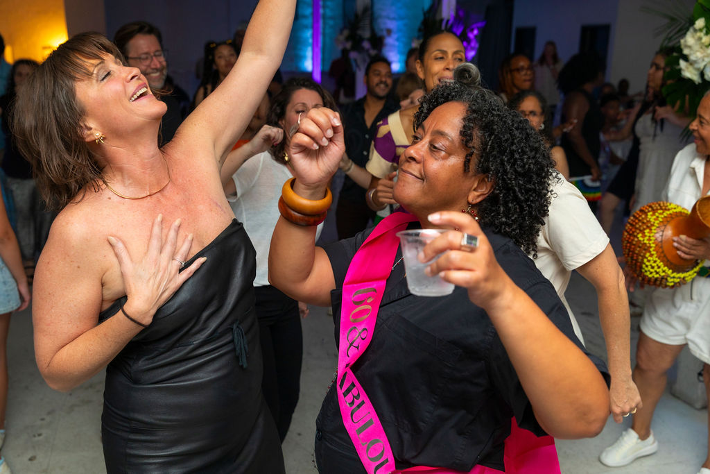 The 60-year-old and a guest dancing together, arms linked