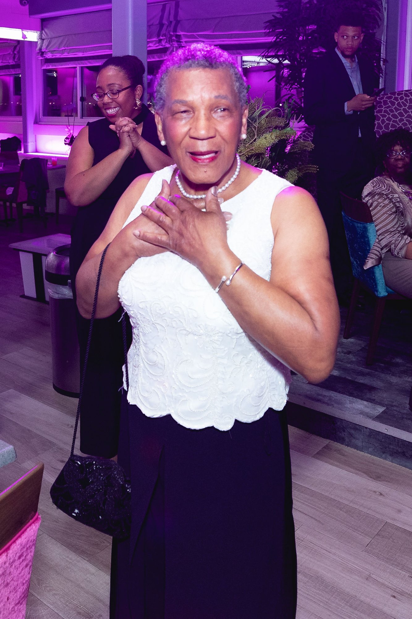 The honoree — hands clasped to her chest, overwhelmed with gratitude