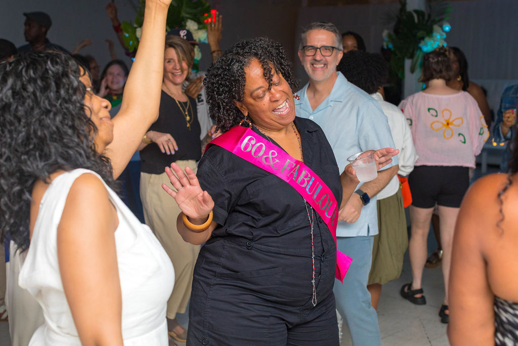 The 60-year-old dancing with guests, hands raised, full energy