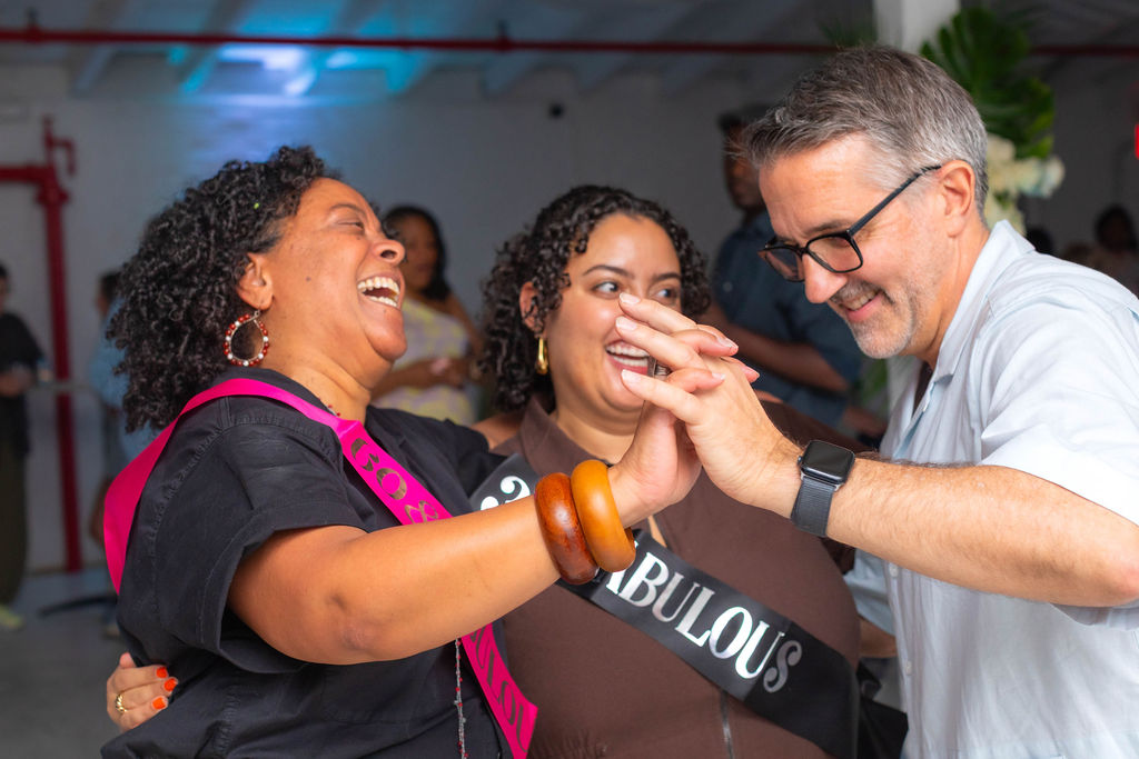 The 60th and 30th high-fiving with a guest — three generations of joy