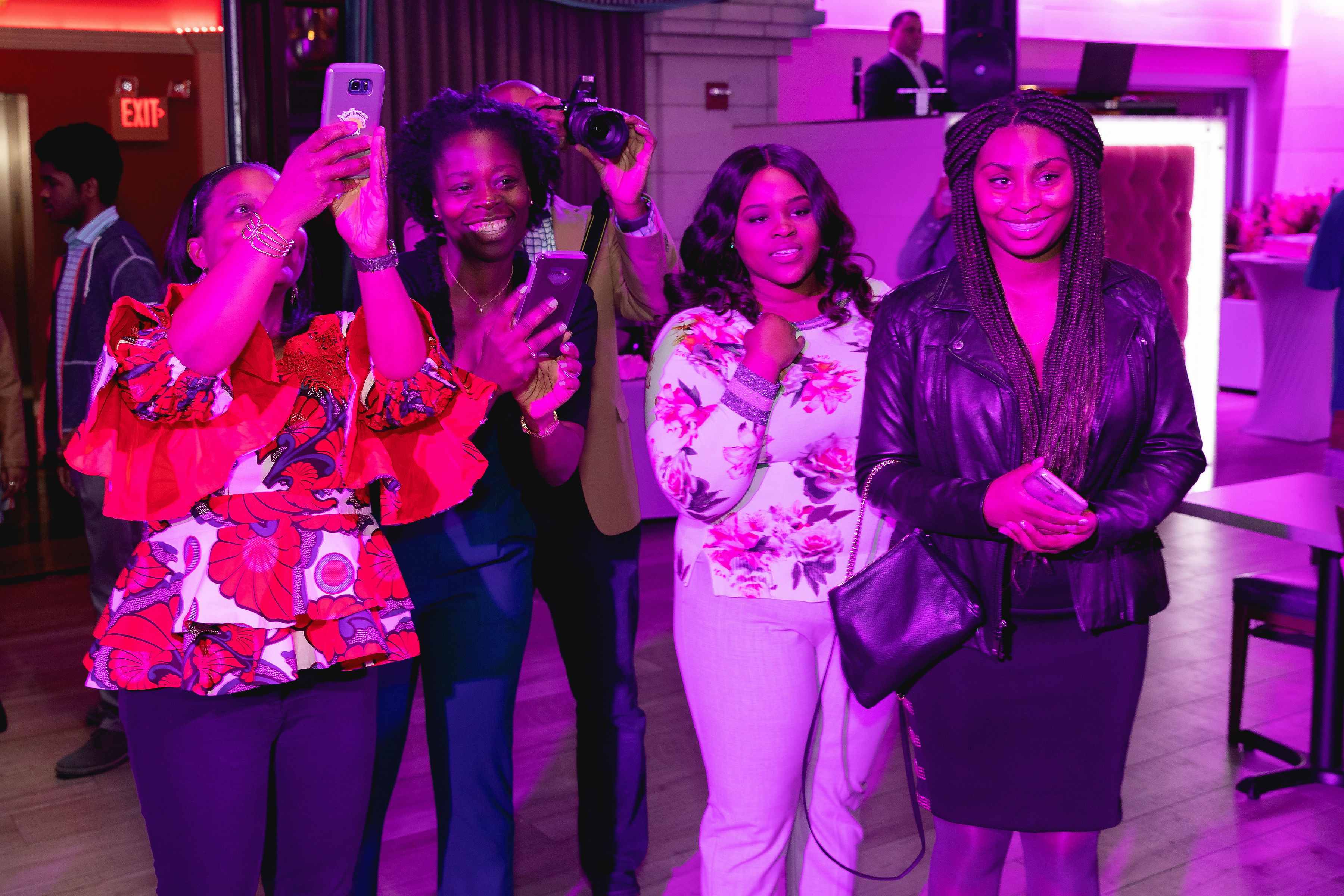 Guests with phones raised, watching and filming the grand entrance