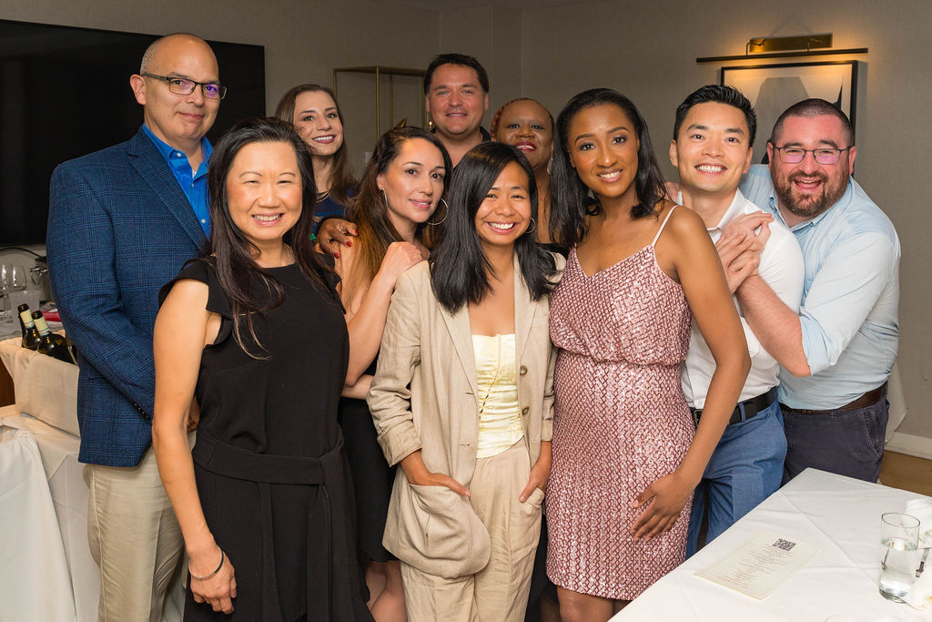 Mixed group of guests smiling together at the end of the evening