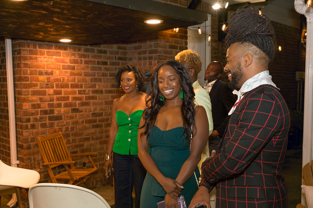 Guests mingling and laughing in the courtyard