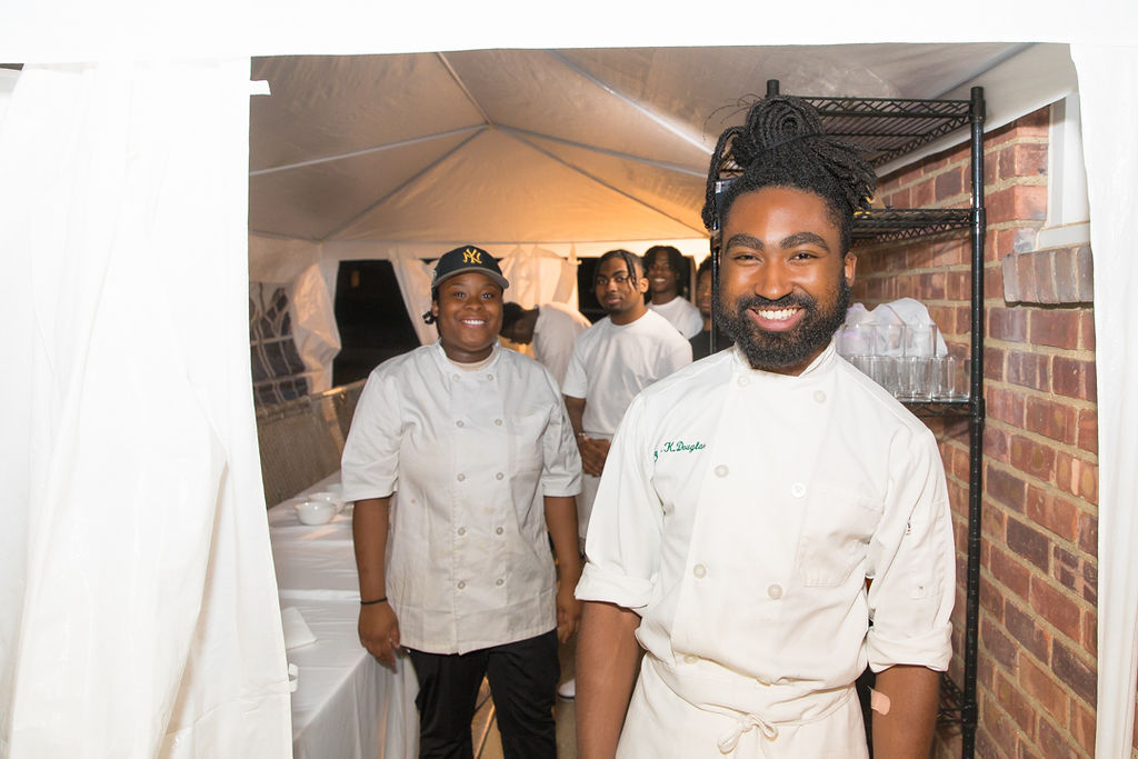 OSC head chef and team member at the kitchen tent entrance