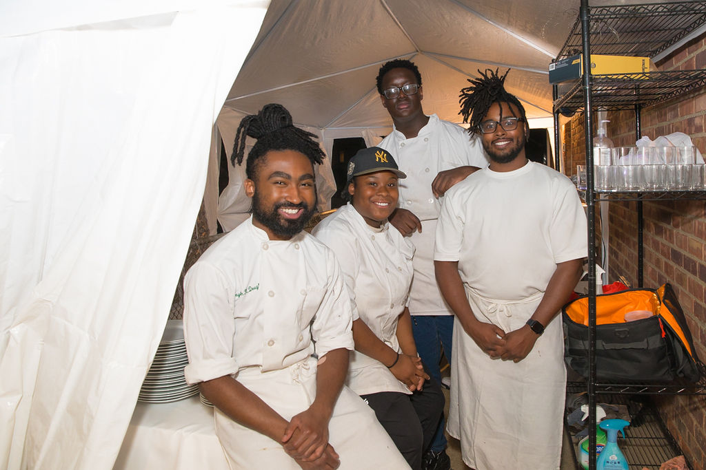 Full OSC catering team portrait in the kitchen tent