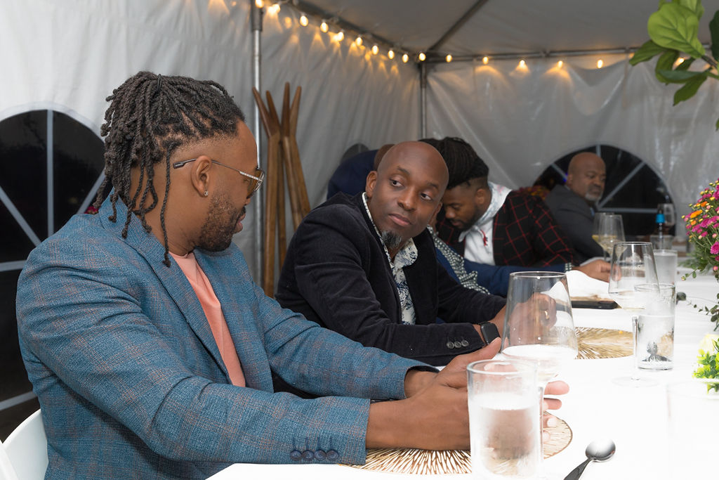 Two men in close conversation at the dinner table