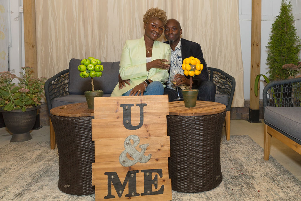 Couple seated at the U and ME sign after the proposal