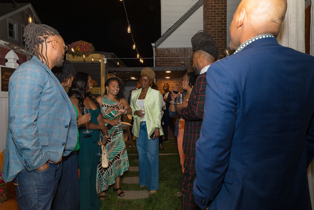 Evening crowd mingling under string lights
