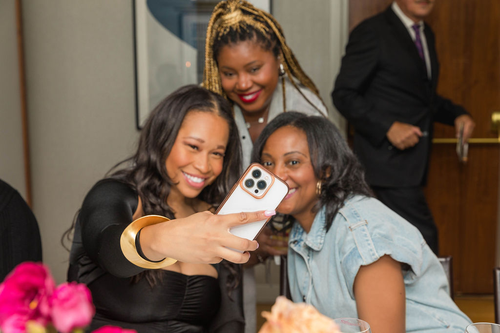 Three women taking a selfie, laughing