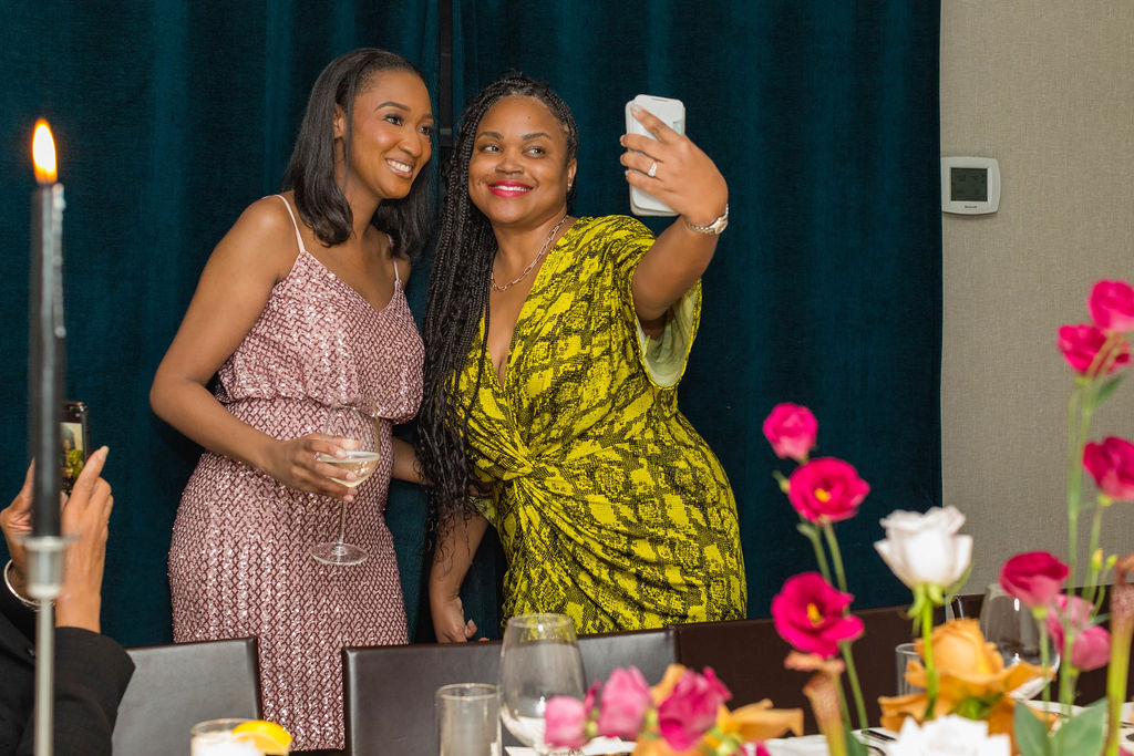 Two women taking a selfie by candlelight