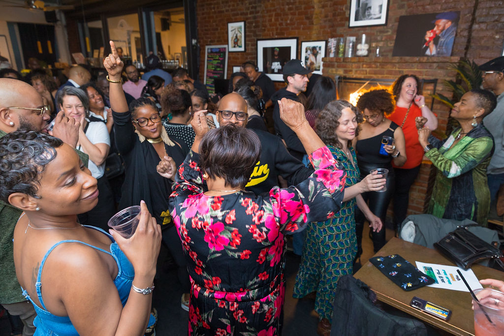 50 and Fly neon sign — two birthday cakes, florals, gold boombox