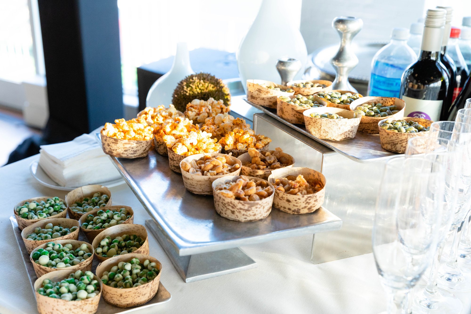 Cocktail hour energy — guests in black tie, florals in foreground