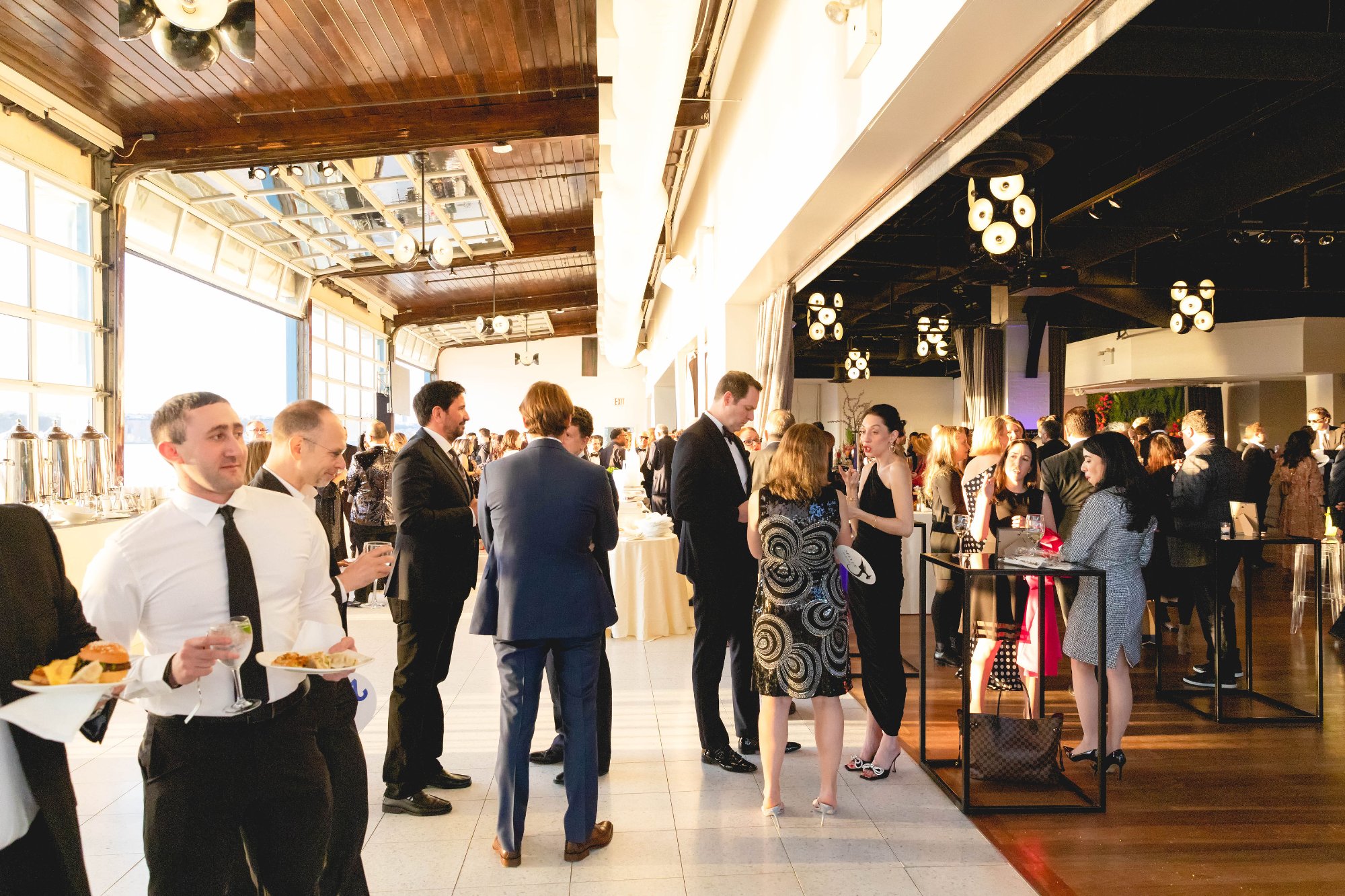 Gala atmosphere — wide room, guests, warm light