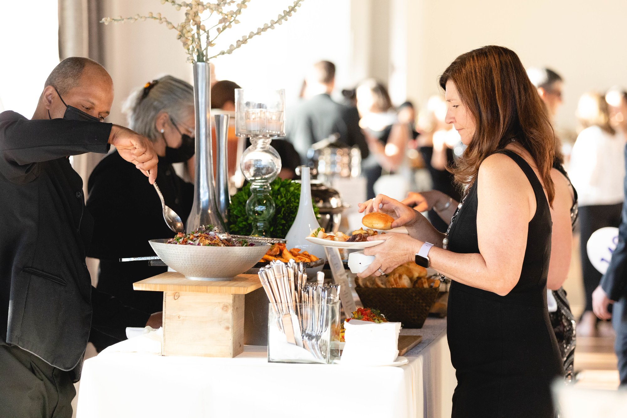Food service detail — server and guest at the buffet station