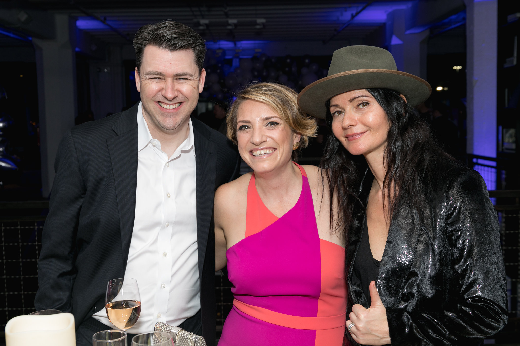 Guest watching the live painting — absorbed, standing close, taking it in