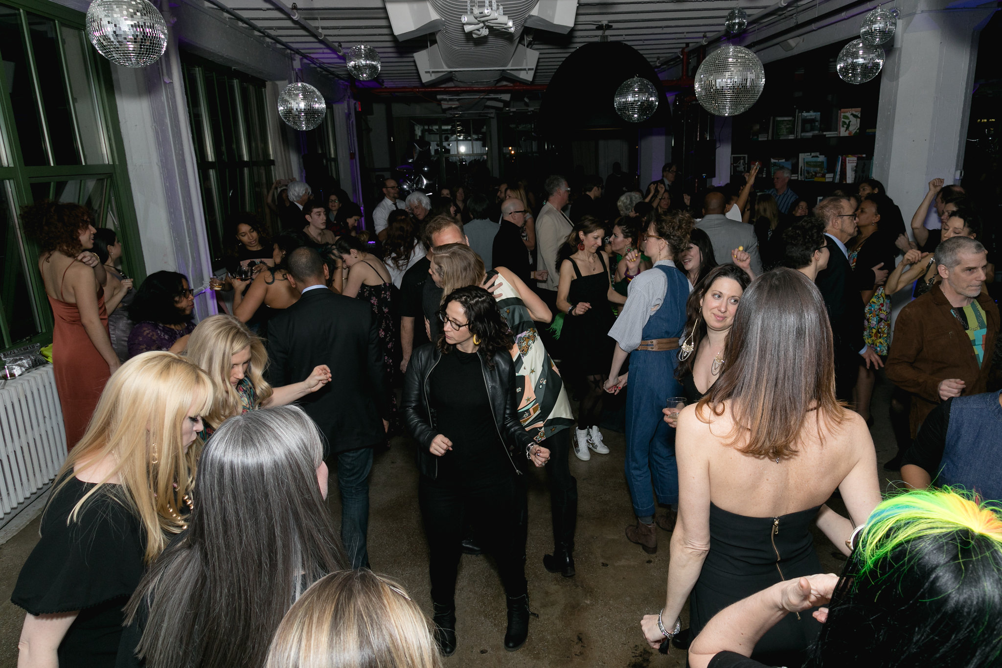 The dance floor packed — disco balls overhead, every corner of the room in motion