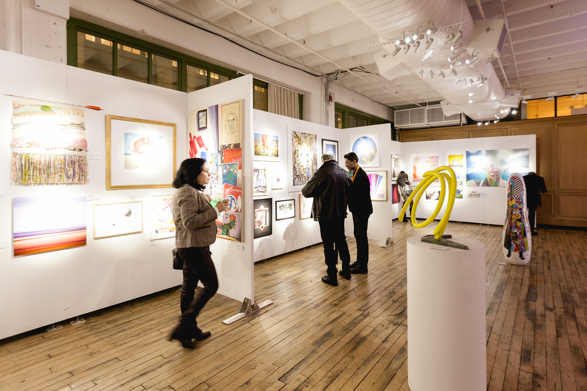 The fine art silent auction gallery — sculptures and paintings filling the room before guests arrive