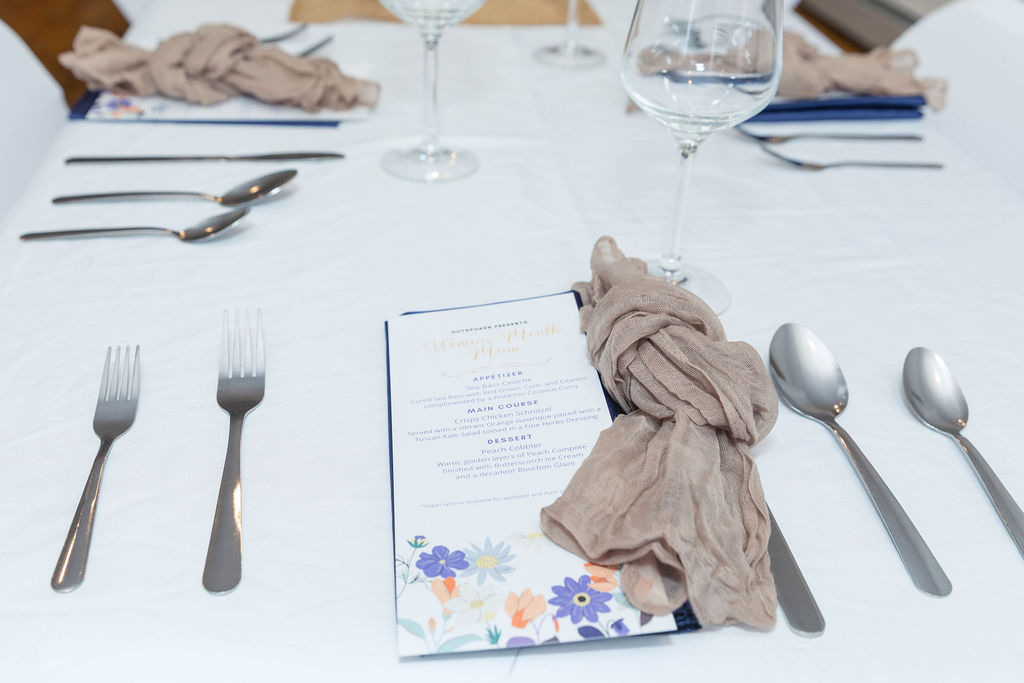 Women's Month Menu card at the place setting — floral print, linen napkin tied