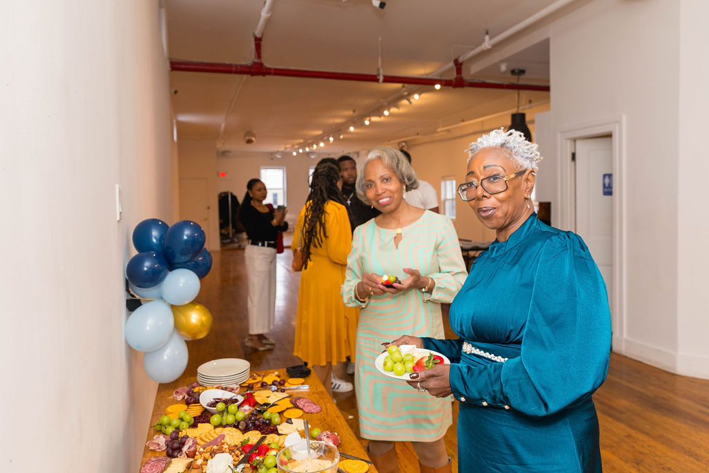The grazing table — charcuterie, fruit, cheese, crackers, balloons in background