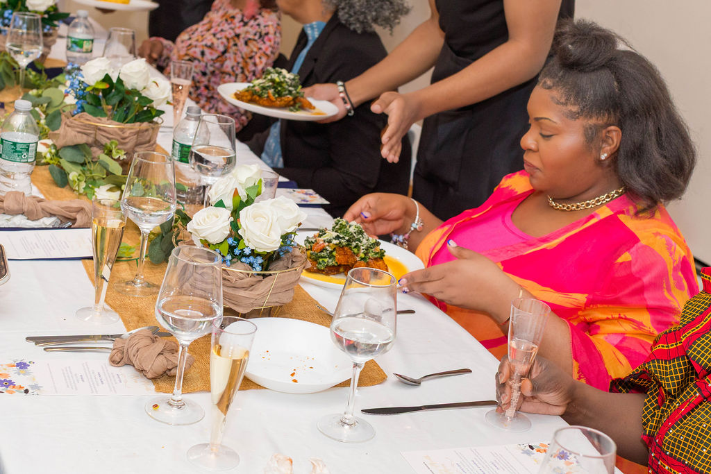 Service in action — plate being set down, guest reacting to the food arriving